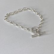 Pulsera rolo de plata con cierre micropave circulo