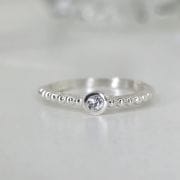 Anillo liso de plata con bolitas y punto luz