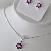 Conjunto flor aros más dije fuccia