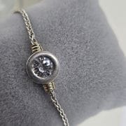 Pulsera de plata y oro con cubic circular en el centro