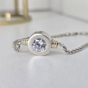 Pulsera de plata y oro con cubic circular en el centro