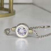 Pulsera de plata y oro con cubic circular en el centro